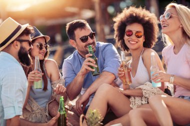 Neşeli grup arkadaşıyla kumsalda eğleniyor.