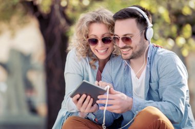 tablet kullanma ve sokakta müzik dinlemek genç çift