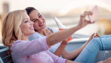 Dostluk için bir tost ekmegi en iyi iki arkadaş. Kızlar günbatımında kokteyller eğlenin.