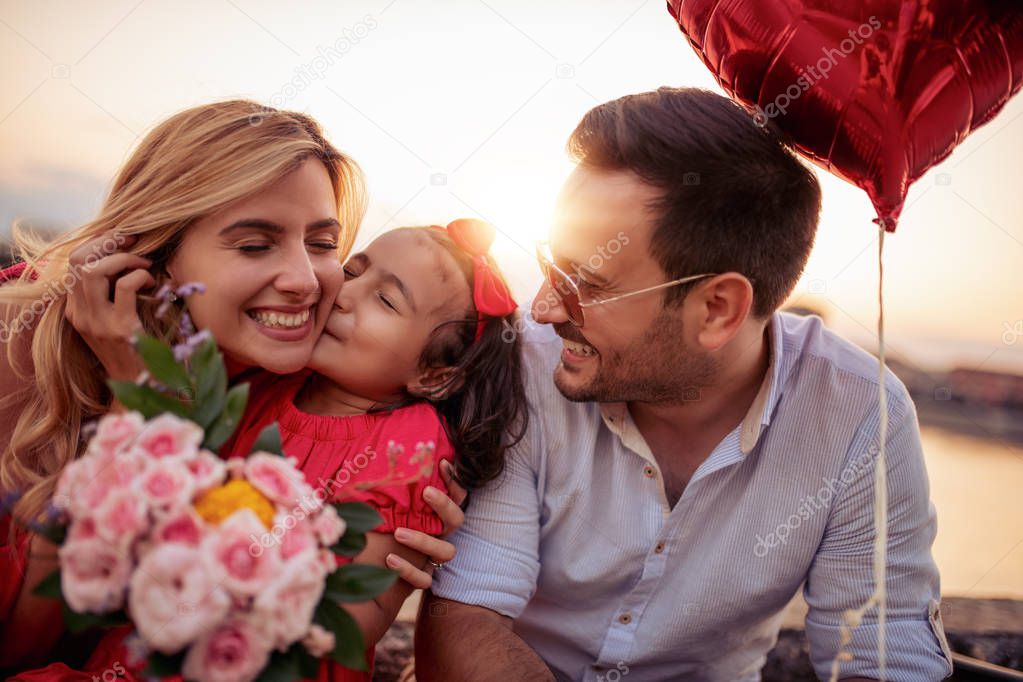 Portrait of happy family having great time in park.