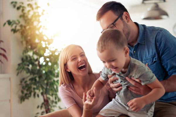 Family time.Mother,father and son having fun at home.