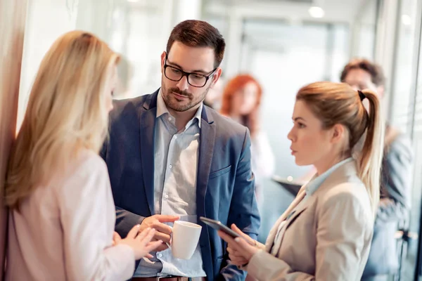 Business people having conversation during coffee break.