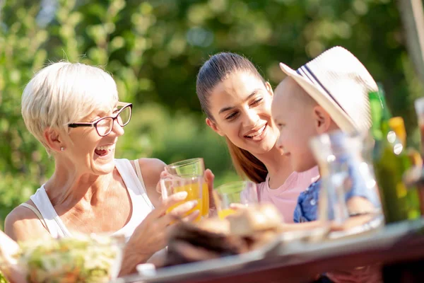 Happy Family Having Barbecue Lunch Garden Sunny Day Drink Orange — Stock Photo, Image