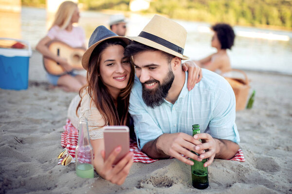 Young beautiful people having fun on summer beach.