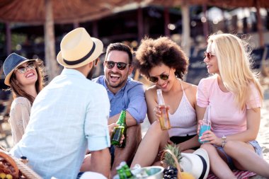 Genç insanlar iyi bir ruh halinde zevk ve sahilde piknik. Yaşam tarzı, aşk, flört ve tatil kavramı.