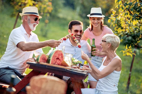 Happy big family having lunch at summer garden party.People,food,love and happiness concept.