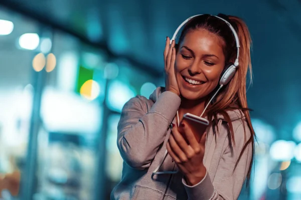 Fitness woman jogging at night in the city.