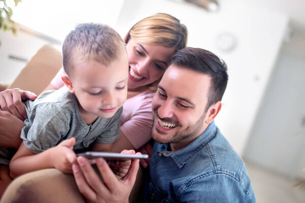 Lovely family enjoying together at home and watching cartoons.