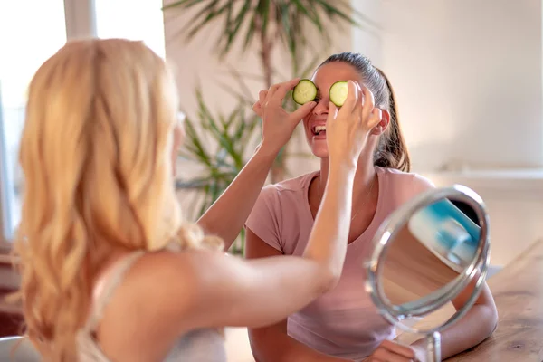 Two Cheerful Women Holding Pieces Cucumber Face — Stock Photo, Image