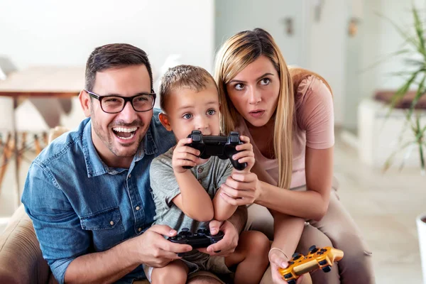 Happy family playing video games at home and having fun together.