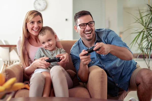 Happy family play video games together.