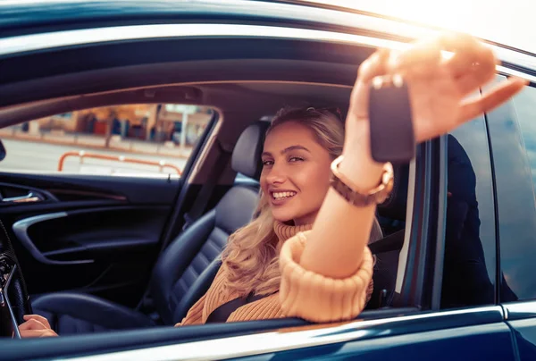 Woman buying a new car at dealership.