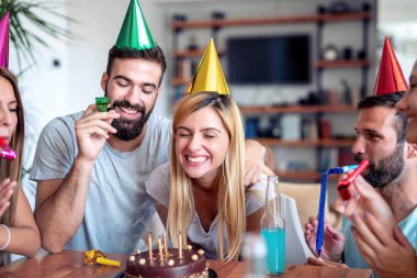 Bir grup arkadaş evde doğum günü kutluyor. Parti, tatil, mutluluk, eğlence ve insanlar konsepti 