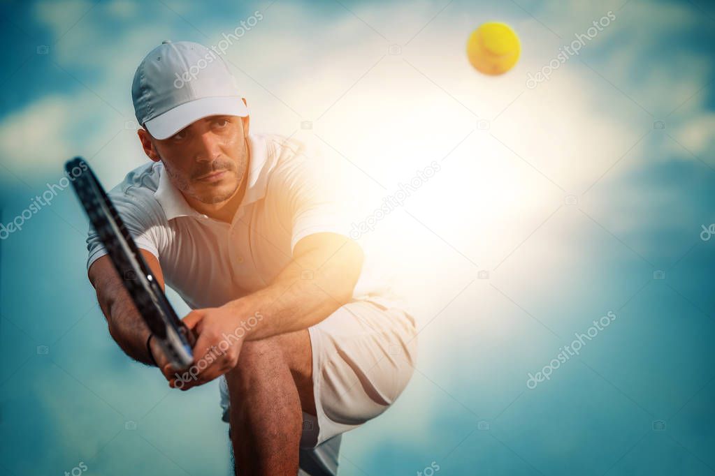 Tennis player focused in ready position.He is on tennis court.