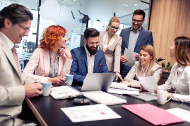 Tam konsantrasyon işte. Ofis masasında otururken çalışan ve iletişim kuran bir grup iş adamı.