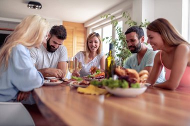 Genç neşeli bir grup insan evde partide eğleniyor.