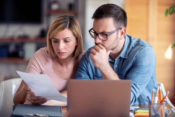 Foto Pareja Joven Usando Laptop Analizando Sus Finanzas Con Documentos —  Fotos de Stock