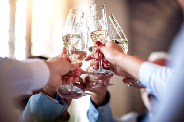 Close up image of business people toasting with champagne.