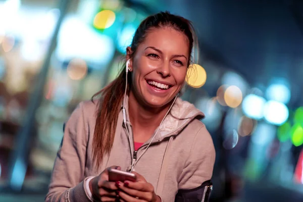 Young fitness woman jogging at night in the city. Fitness,people and workout concept.