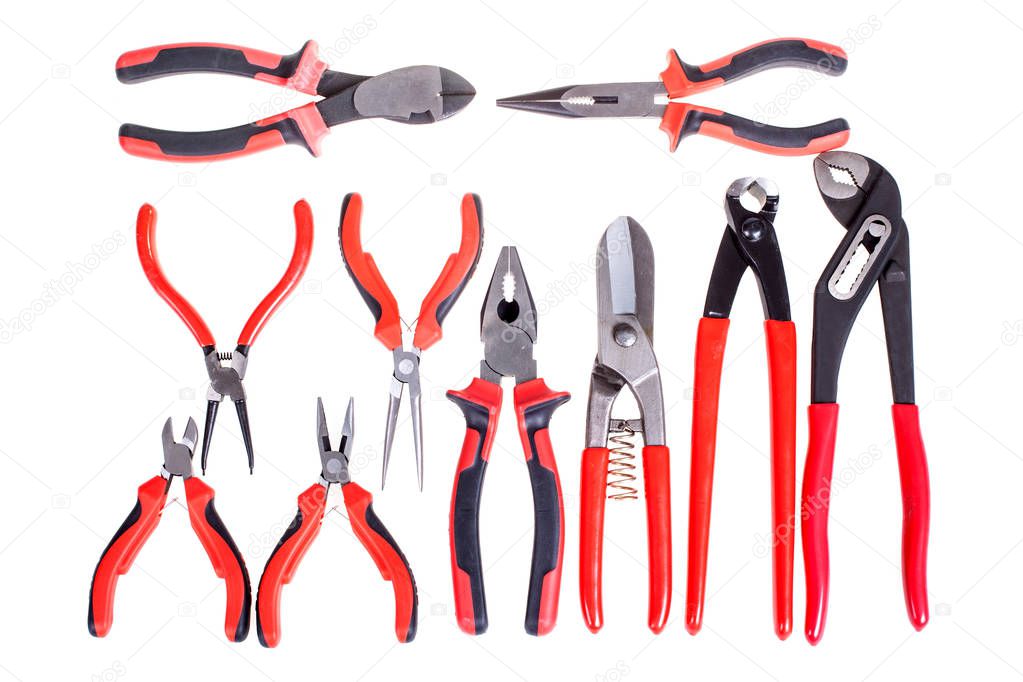 Various pliers, nippers set isolated on white. Tools related to construction, carpentry, repairing works. Top view.