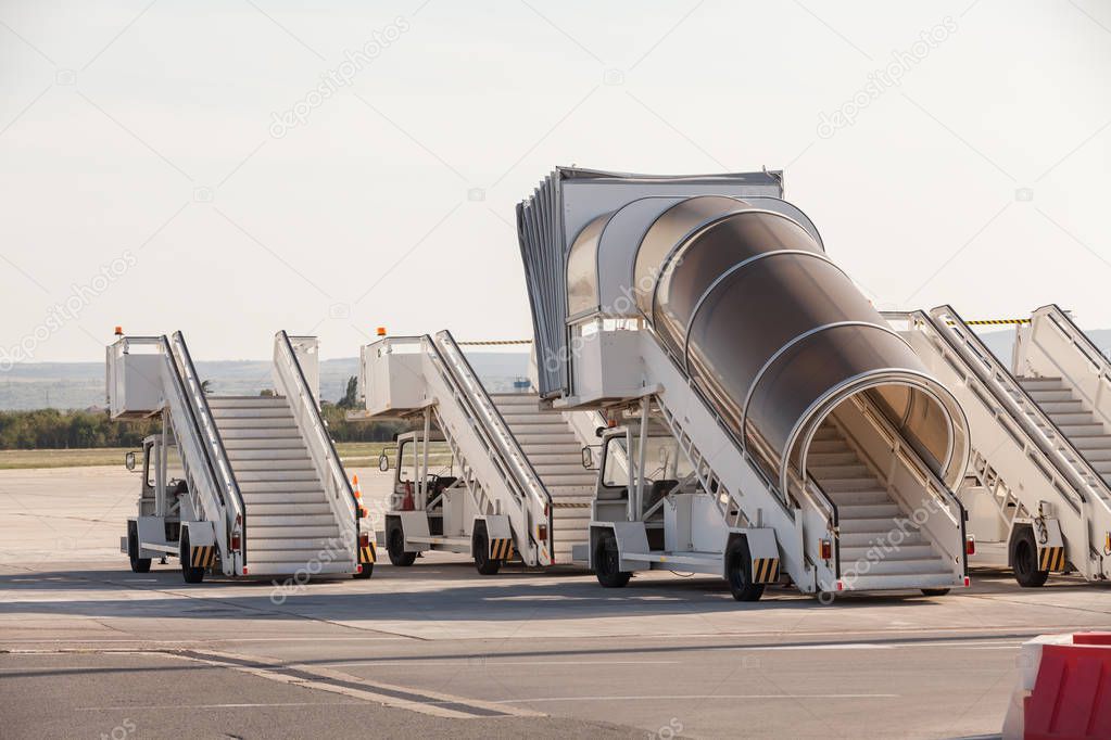 Gangways of airplan at the airport. Passenger's boarding ramps. Passenger's ladders. Traveling and waiting for flight at the airport