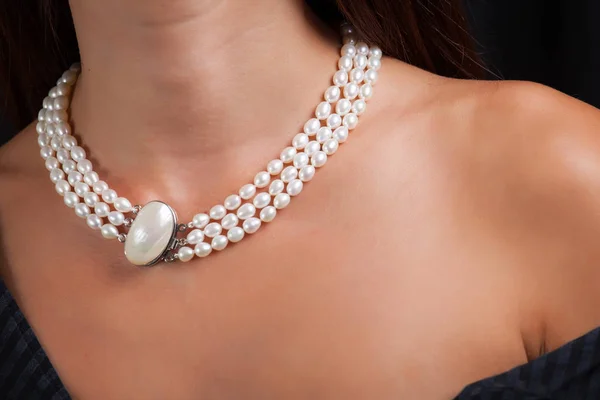 Woman with pearl necklace on her neck