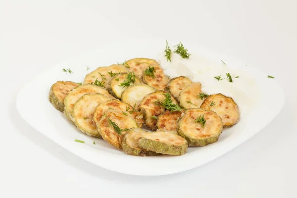 Fried zucchini with yogurt in white plate. Top view — Stock Photo, Image