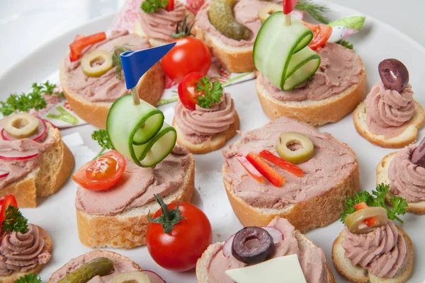 Party platter with sandwiches with pate and vegetables — Stock Photo, Image