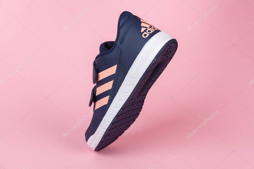 Varna , Bulgaria - AUGUST 13, 2019 : ADIDAS ALTA SPORT  shoe, on pink background. Product shot. Adidas is a German corporation that designs and manufactures sports shoes, clothing and accessories