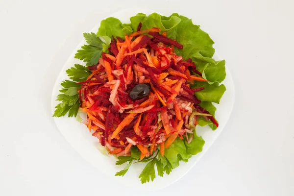 salad of fresh beets and carrots in white plate. From above