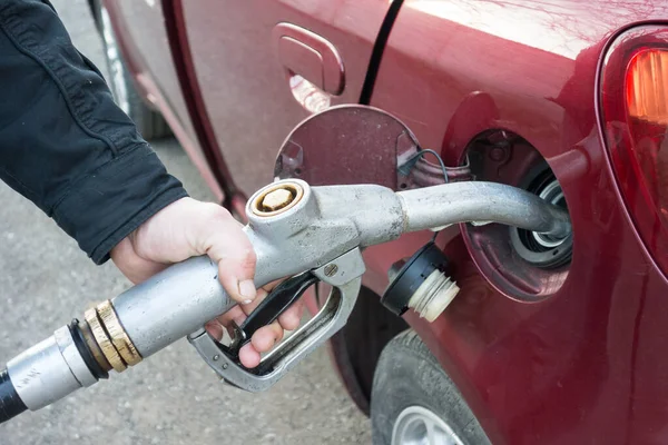 stock image close-up of a hand pumping gas in the car with a gas pump