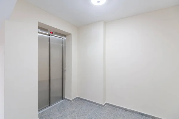 Modern elevator in residential building. Lobby interior with elevator door
