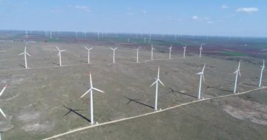 Bir rüzgar türbininin 4K hava aracı görüntüsü. Elektrik üretimi için yel değirmeni. Yeşil enerji. Yenilenebilir enerji.