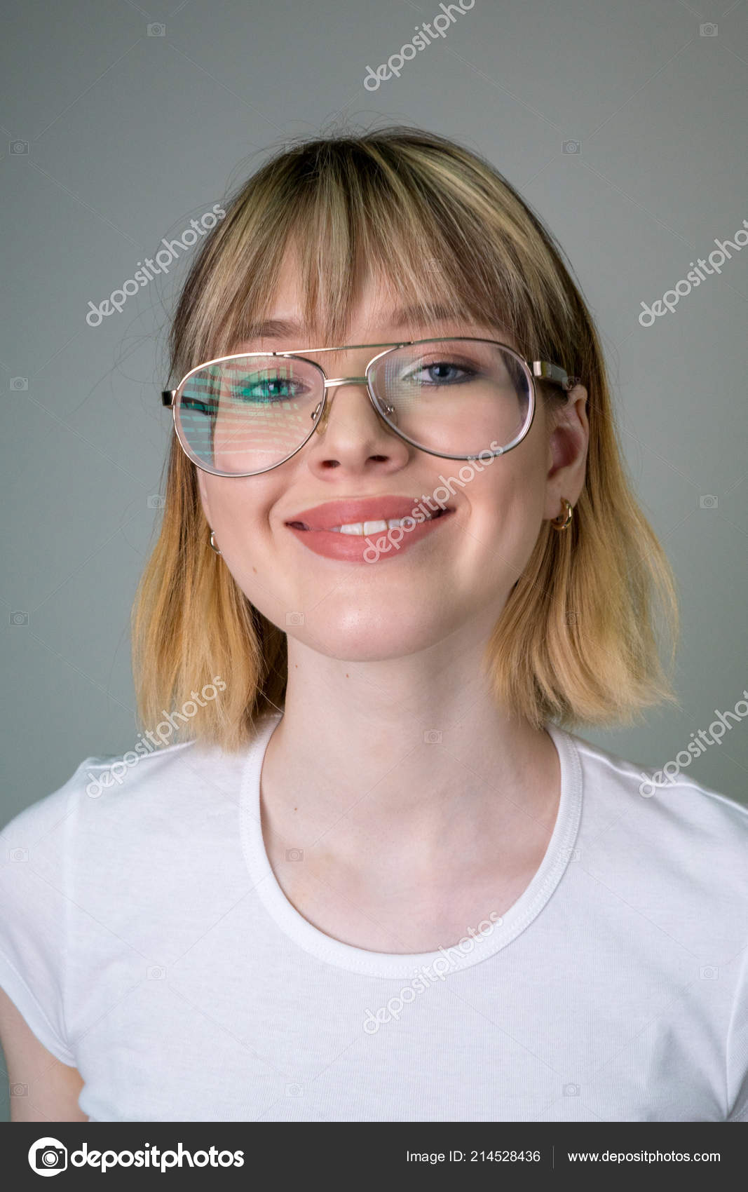 Portrait Of A Beautiful Girl In Glasses With Short Blond Hair