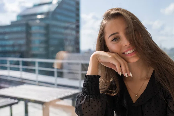 Atractive woman sitting on window sill near window at home. — Stock Photo, Image