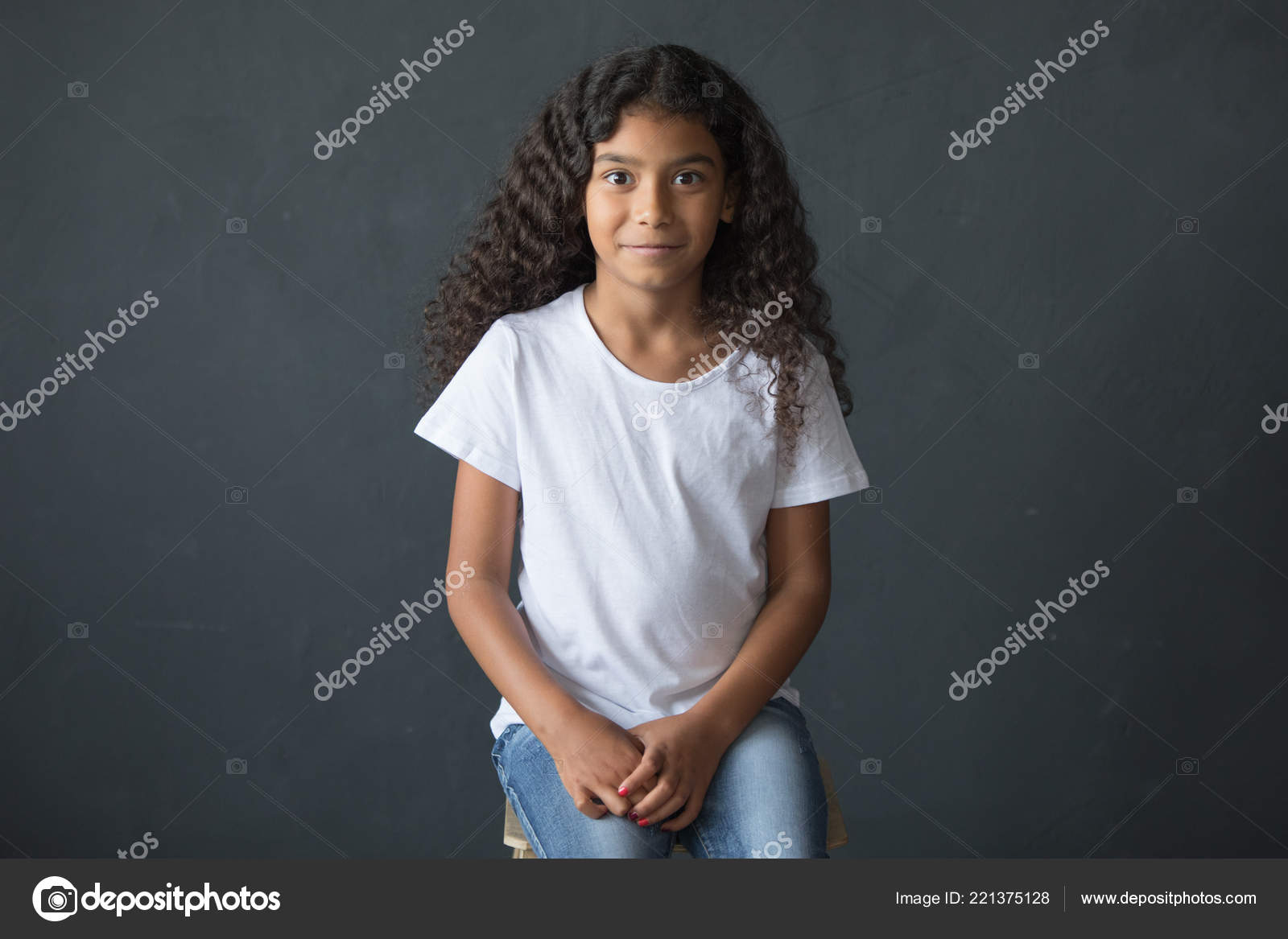 Little African American Girl With Long Curly Hair In A White T