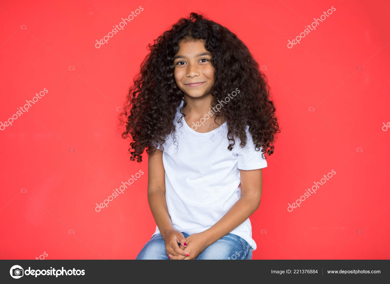 Little African American Girl With Long Curly Hair In A White T
