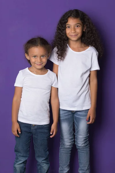 Cute little african american girls in white t-shirts. Mock-up.