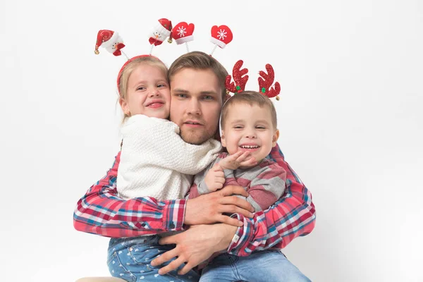 Père avec des enfants dans les bandeaux de Noël drôles sur fond blanc . — Photo