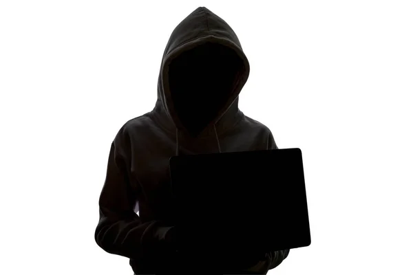 A woman in a hood is using a laptop. Hacker is using a laptop. — Stock Photo, Image