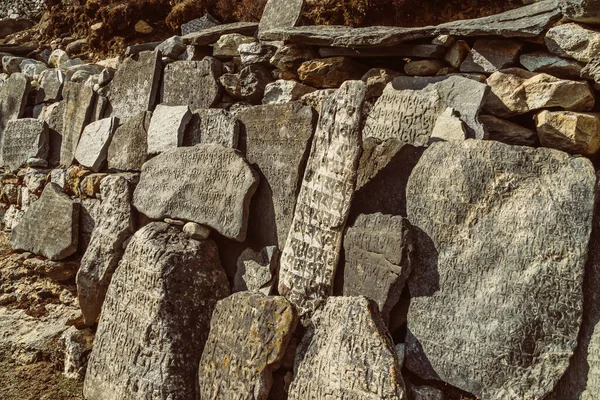 Buddhist prayer symbols on stone on the way to Everest base camp, Nepal