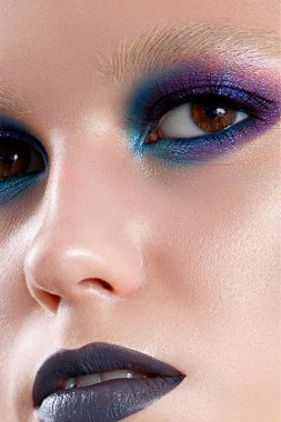 Gotik tarzı parlak ve parlak bir makyaj ile genç bir kız. Güzel model parlak deri ve deri elbiseli. Stüdyoda yapılan portre. Portre