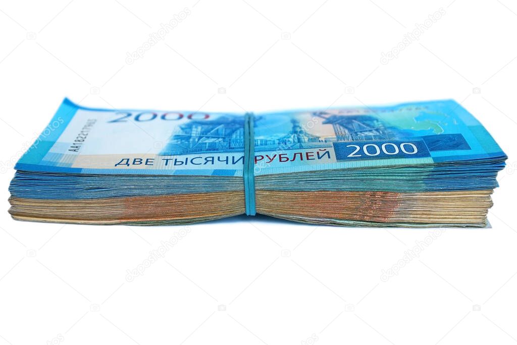 Stack Russian banknotes fastened with an elastic band. Bills with a face value of 2000 two thousand and 5000 five thousand rubles.