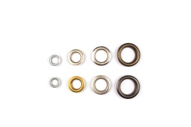 Set of brass multicoloured metal eyelets or rivets - curtains rings for fastening fabric to the cornice, isolated on white with copyspace for text for your presentation clipart