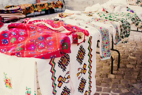 Lviv, Ukraine - August 09, 2020 : garage sale in town hall, Tlum and Kram. Ukrainian clothes - traditional embroidered shirts. Secondhand goods on flea market, thrift shopping concept — Stock Photo, Image