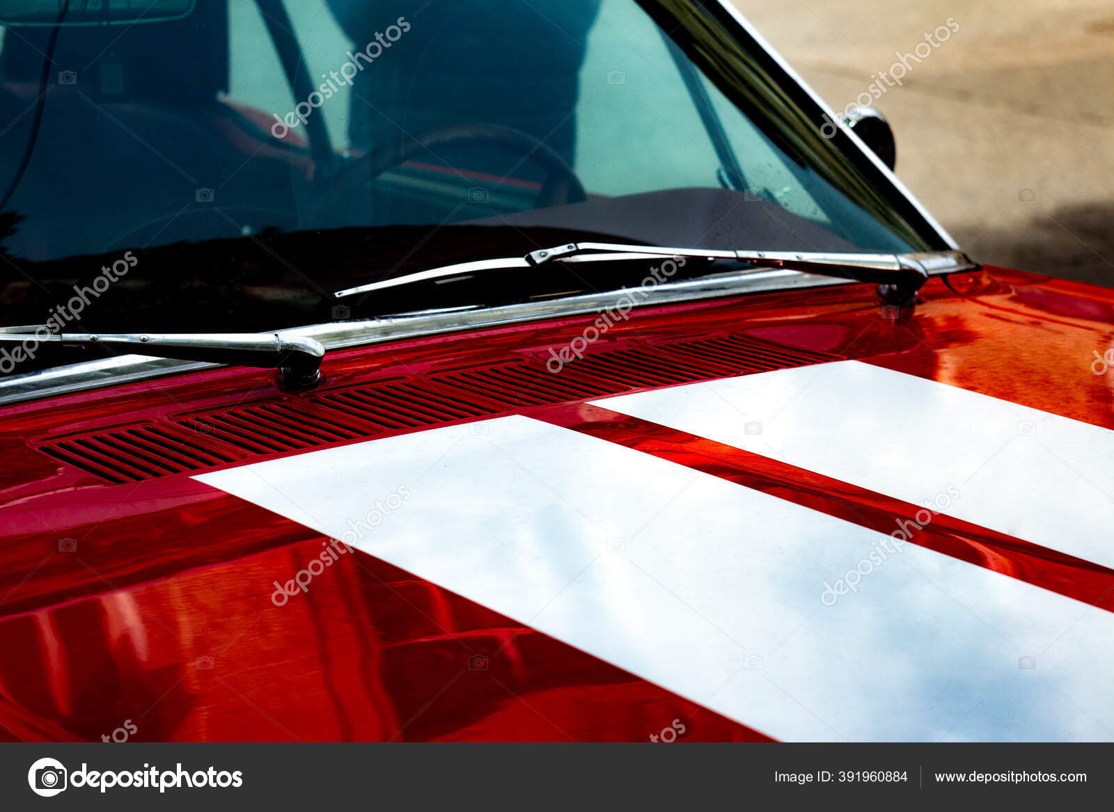 The windshield of an old vintage car is red, with two white stripes on