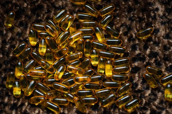 many capsules of gold color lies on the leopard skin