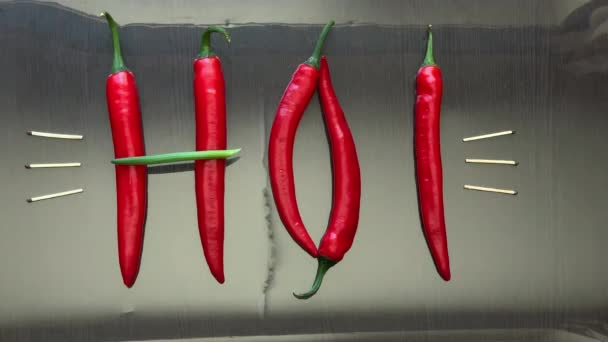 Pimiento picante rojo y cebollas presentaron la palabra caliente en la superficie del espejo — Vídeo de stock