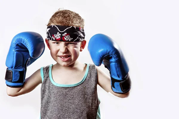 Lutando menino em luvas de boxe e bandana no fundo claro — Fotografia de Stock