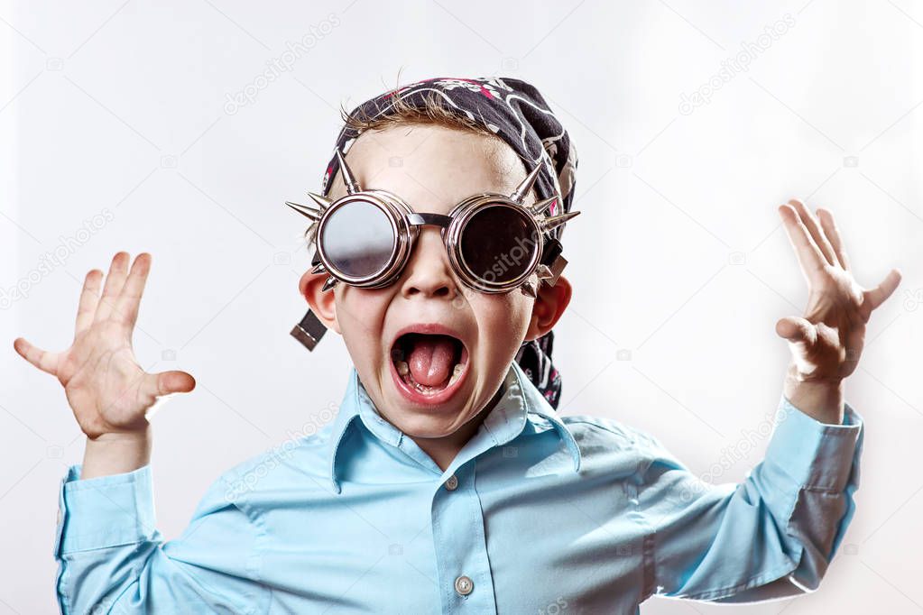 boy rocker in blue shirt, biker glasses and bandana on a light background